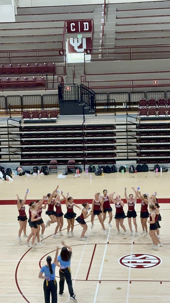 Pom team celebrating their superior rating