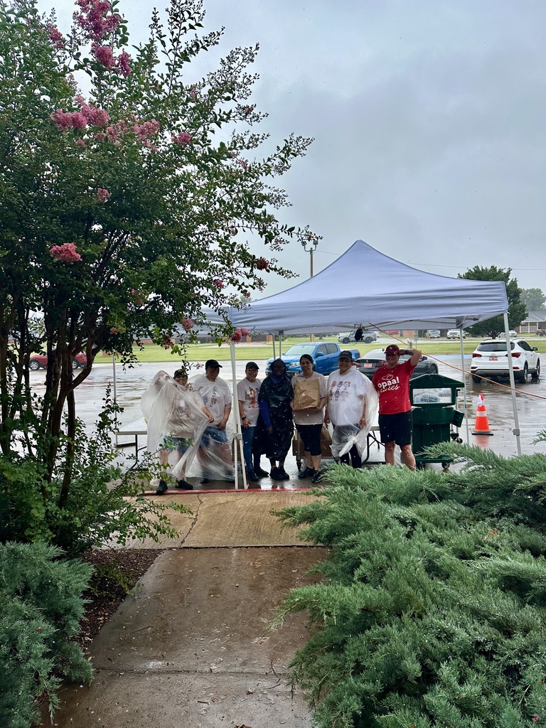 Kitchen crew in the rain handing out meals