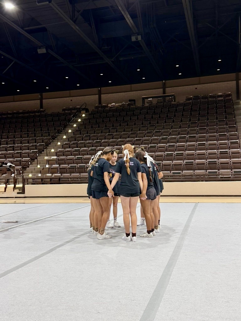 CHS Cheer holding hands in a huddle