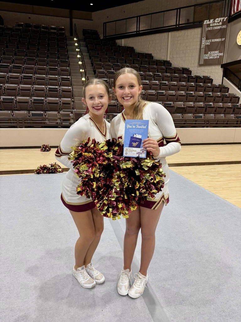 2 CHS cheerleaders holding pom poms