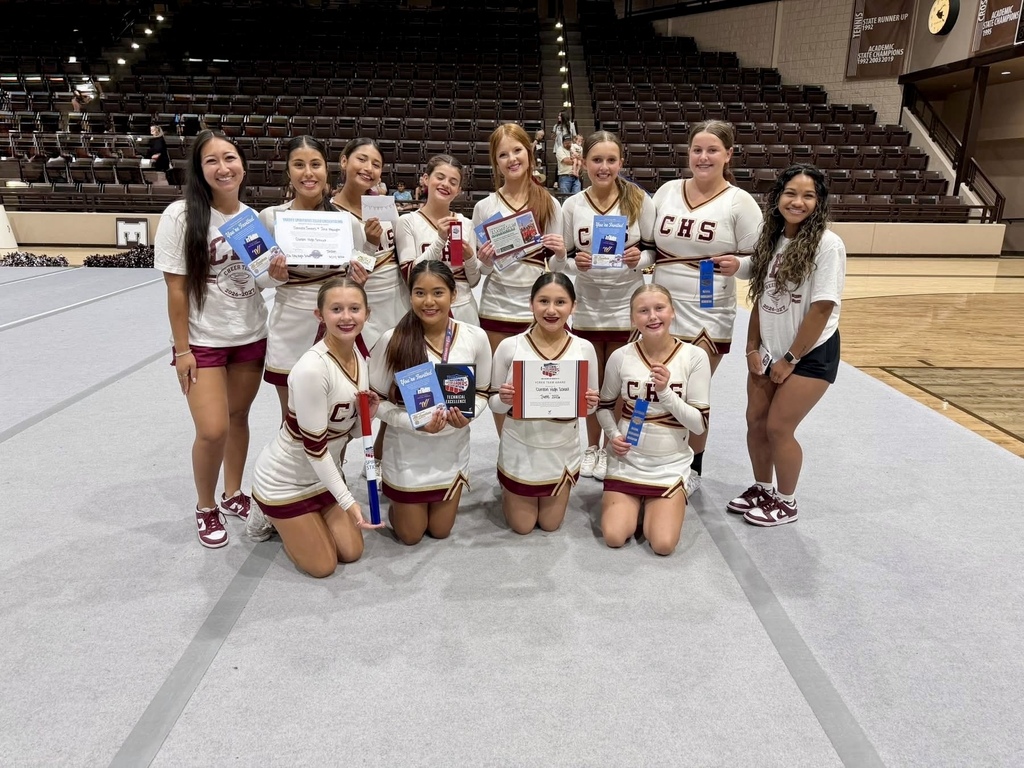 CHS Cheer coaches and team smiling and holding their camp awards