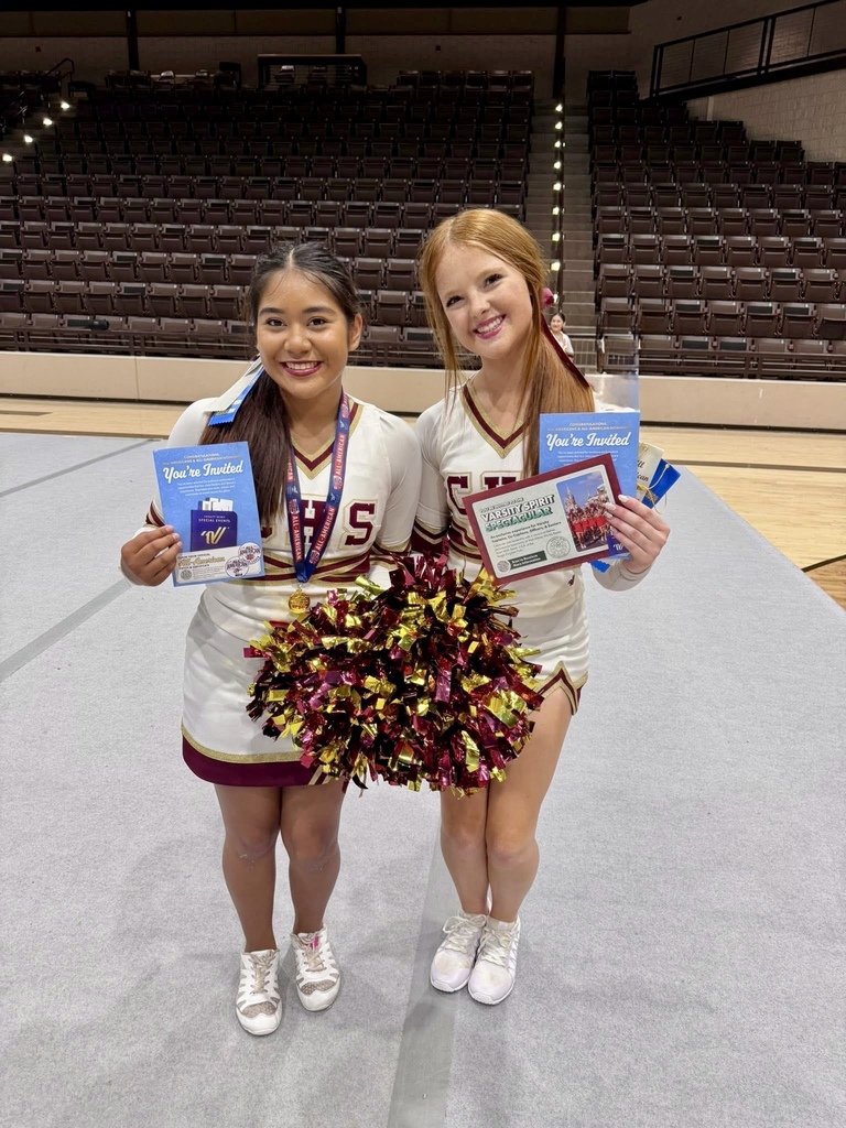 2 cheerleaders holding pom poms and awards from camp