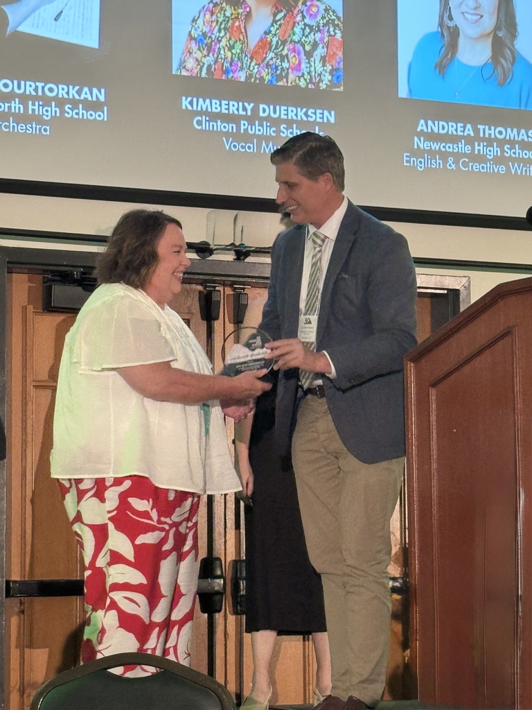 Vocal teacher receiving Transformative Teacher award from Dept of Education Secretary