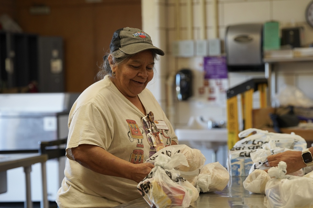 Kitchen staff preparing bags of food