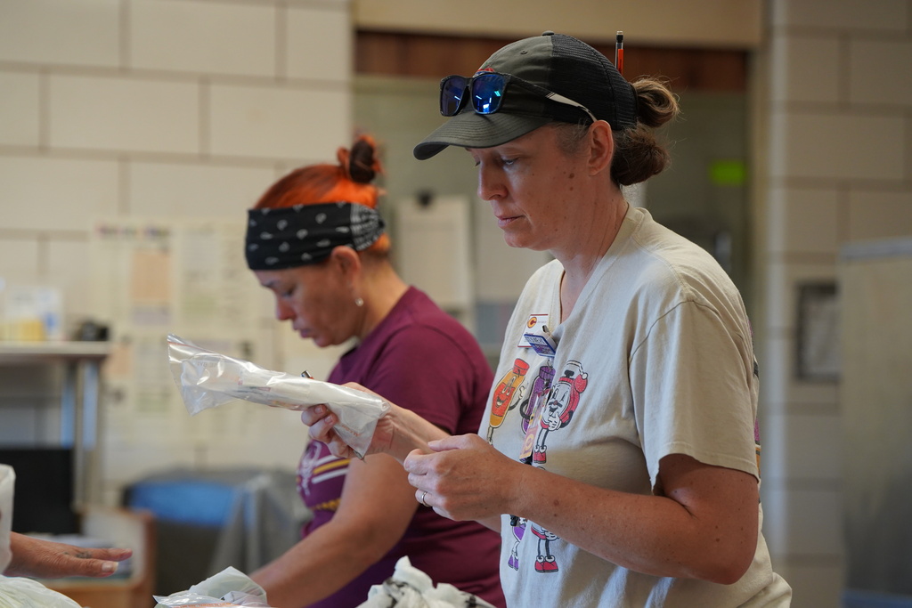 Kitchen staff looking over condiments