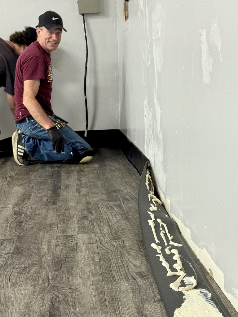 Maintenance worker working on trim in the resource center