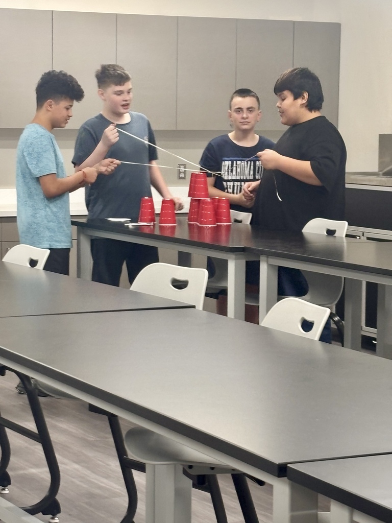 Students using pulleys on cups