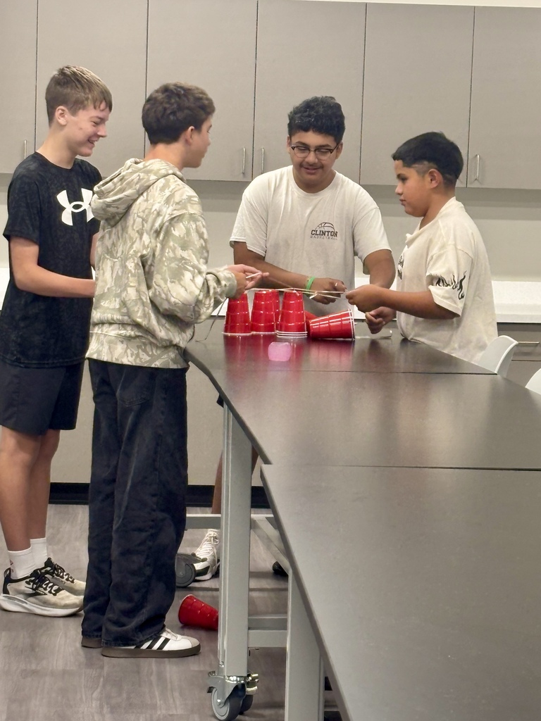 Students trying to stack cups