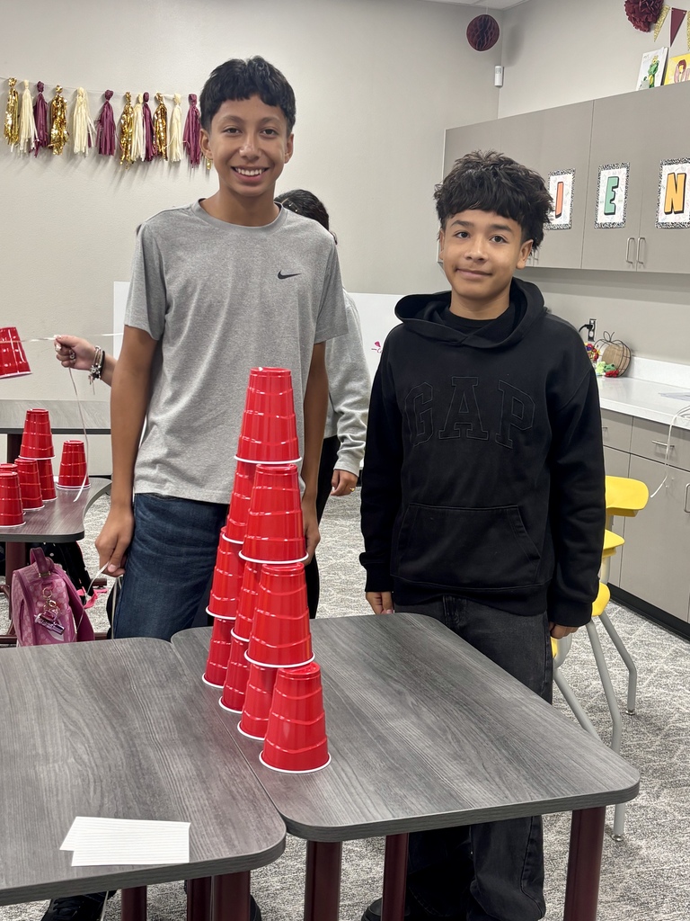 Students standing with cups on table