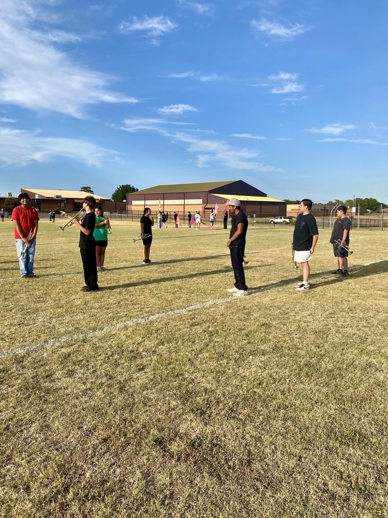 Band members listening to instruction from their section leader