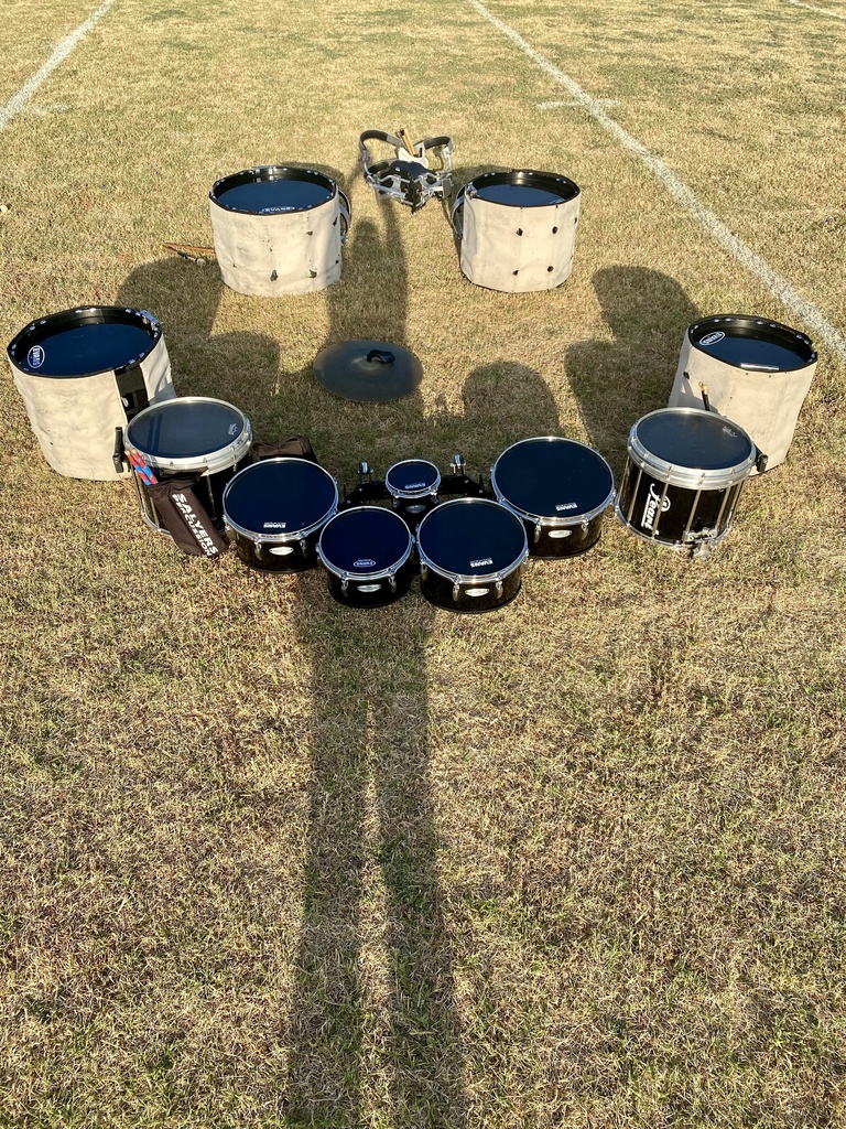 Drums placed in a circle on the field