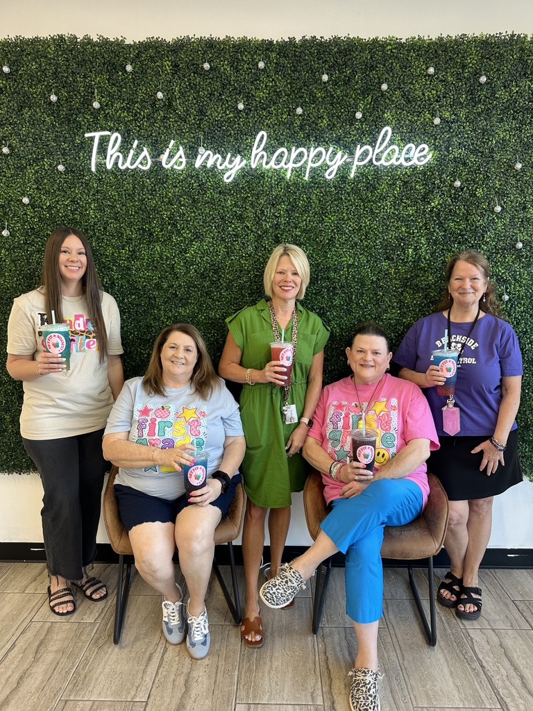 Nance teachers smiling and holding teas