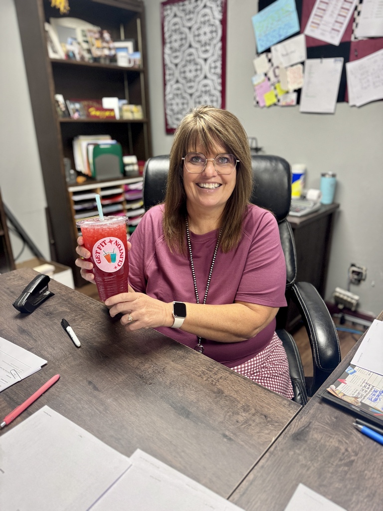 CHS secretary smiling and holding a Fit drink