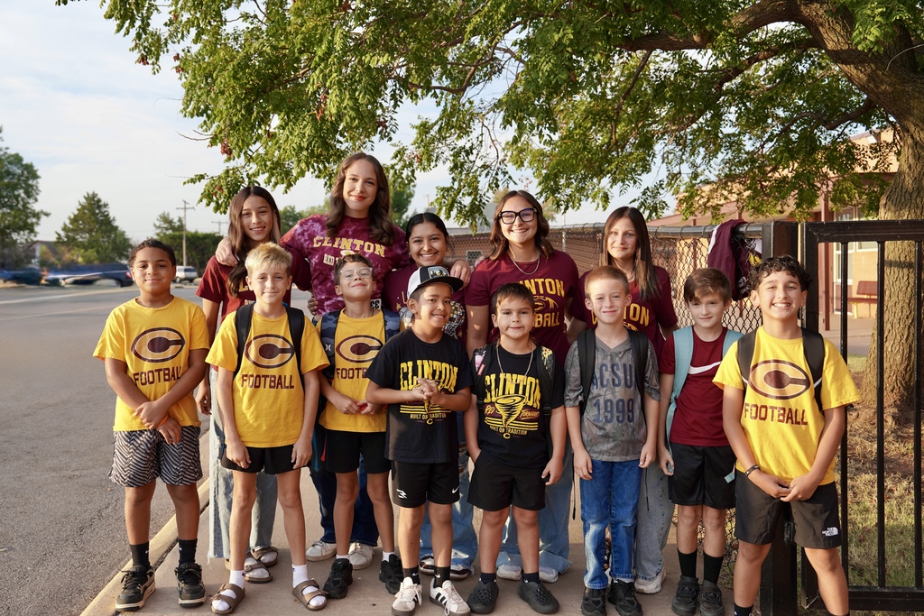 Football trainers, students, and munchin managers greeting students at Southwest