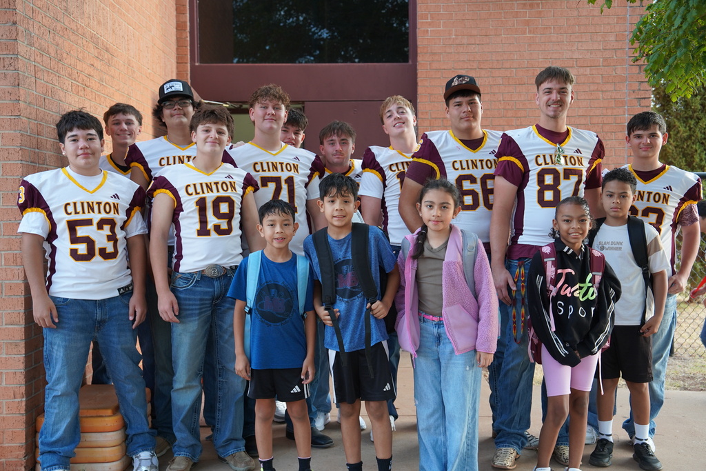 Clinton High School football players posing with Southwest students