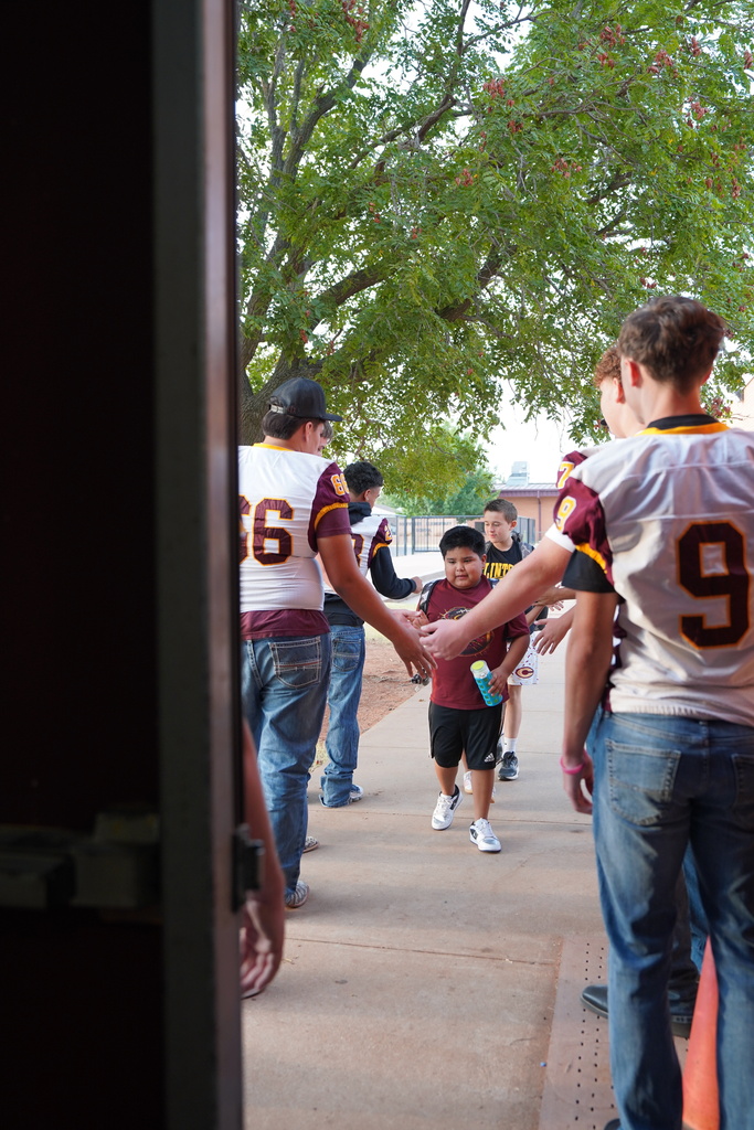 Student walking through football team