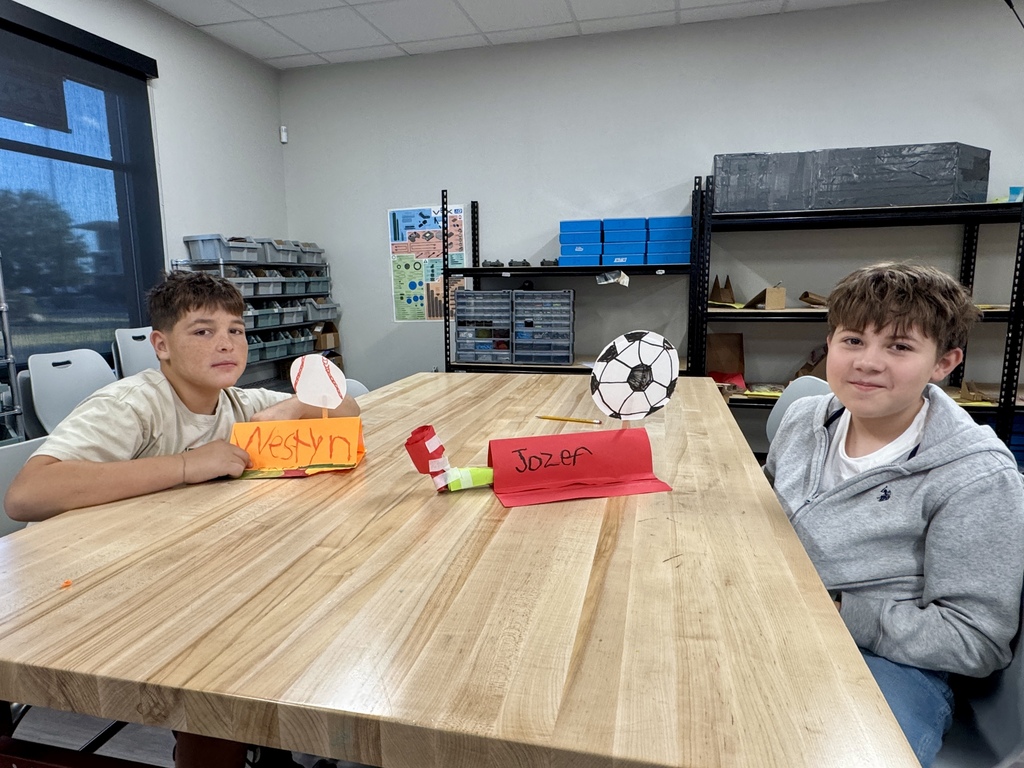 2 students displaying their name plates