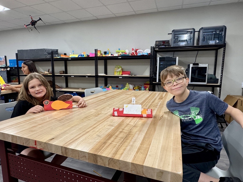 2 students showing their unique name plates