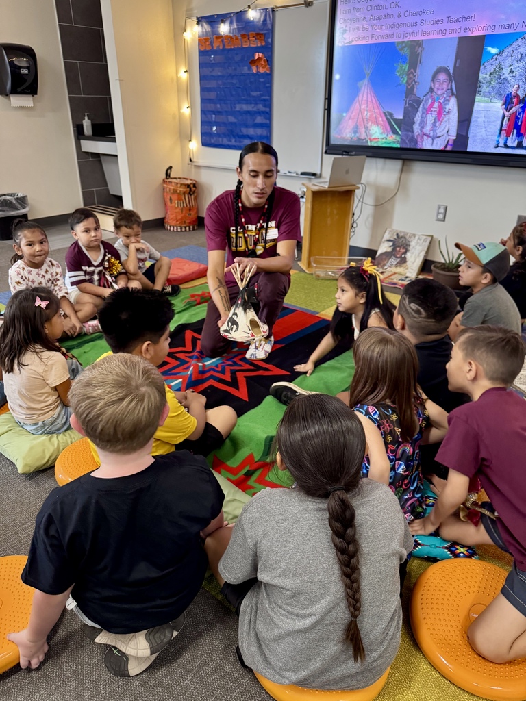 Mr. Goodblanket showing Nance students a model of a teepee