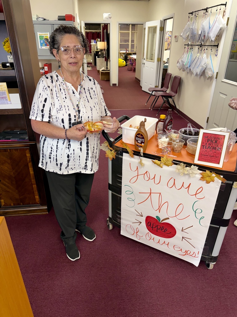 Southwest secretary holding her apple cart creation