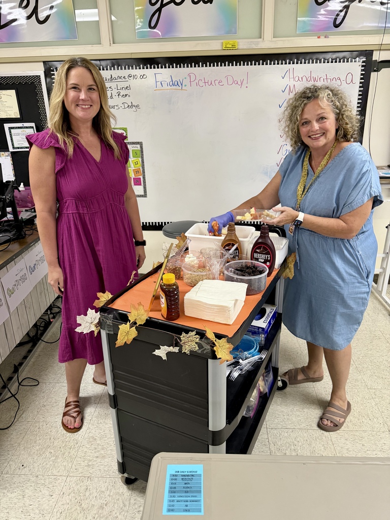 2 teachers preparing their apple cart treats