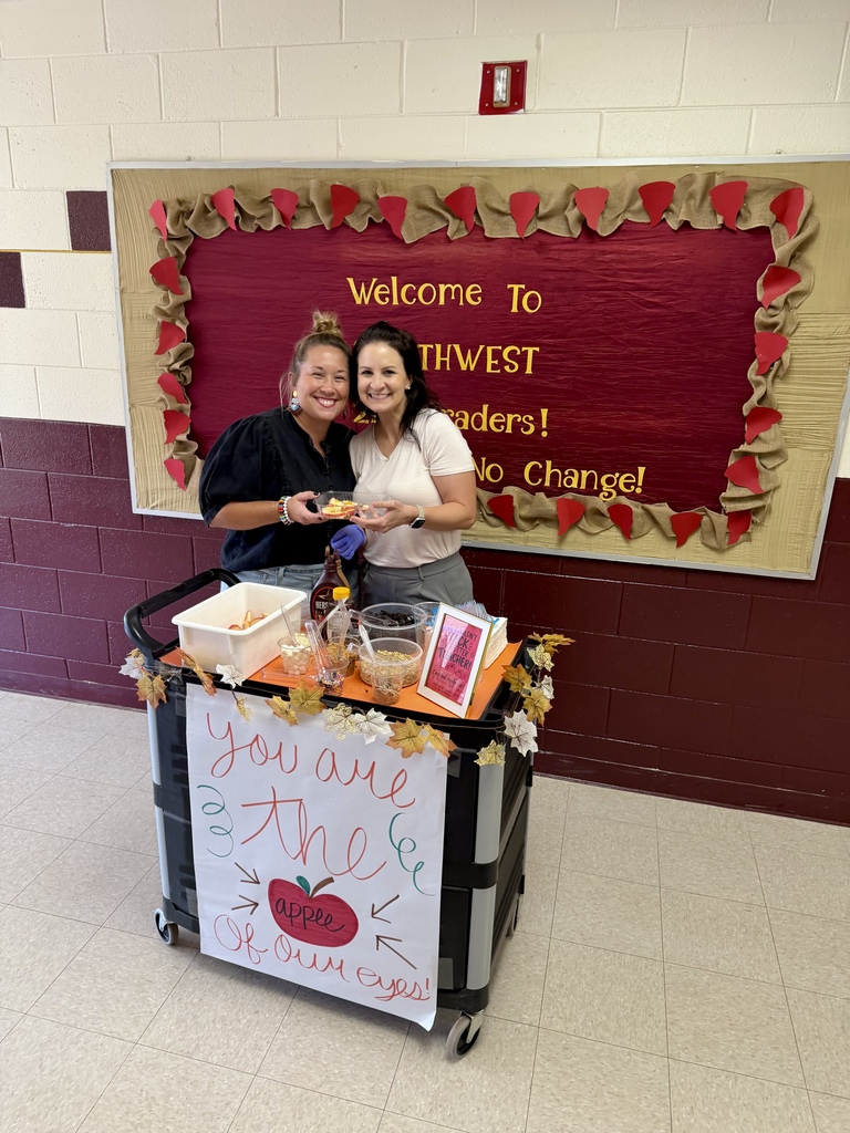 Southwest teacher and counselor smiling with the teacher's apple cart treat