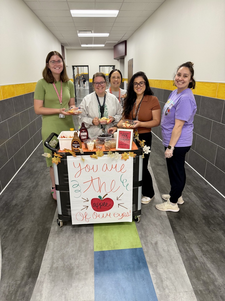 5 teachers in the hallway with the apple cart