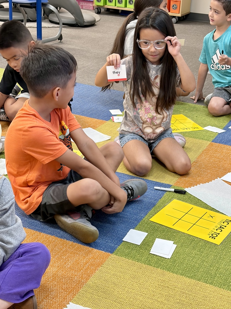 Student showing another student a red word