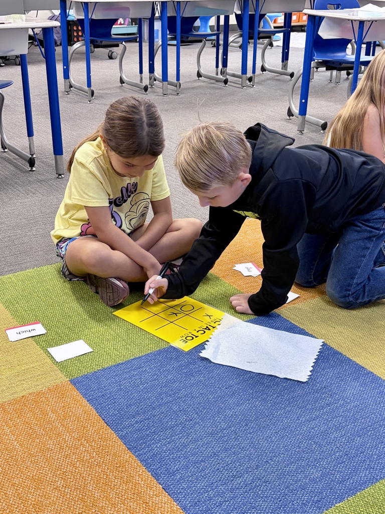 2 students looking at their red words