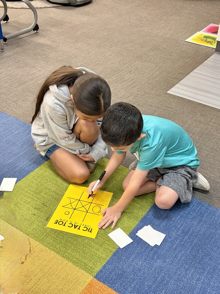 2 students playing tic-tac-toe
