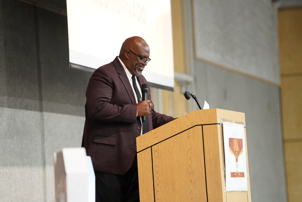 Athletic Director Eugene Jefferson at the podium