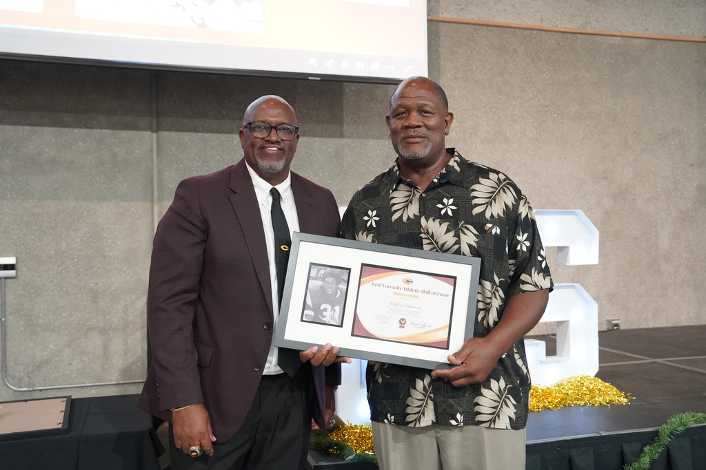 Athletic Director Eugene Jefferson presenting award to Clifford Chatman