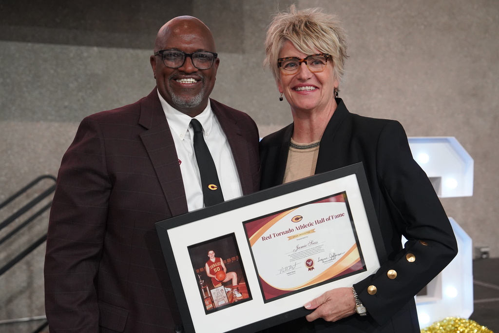 Athletic Director Eugene Jefferson presenting award to Jamie Siess