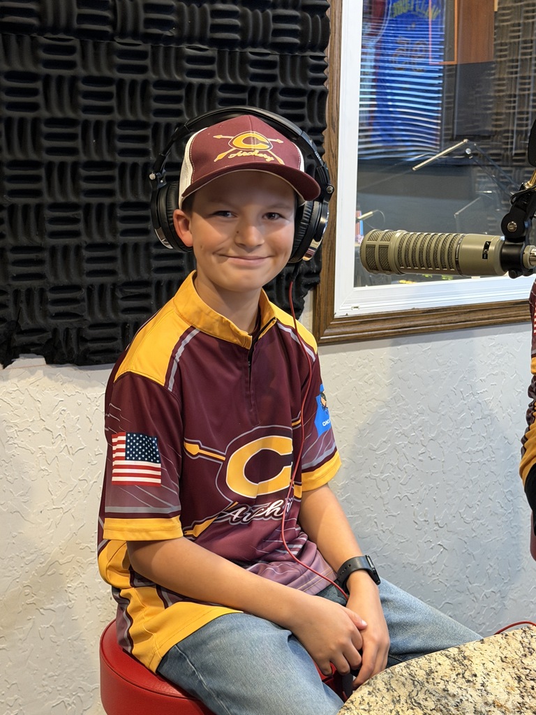Archery student wearing headphones and smiling