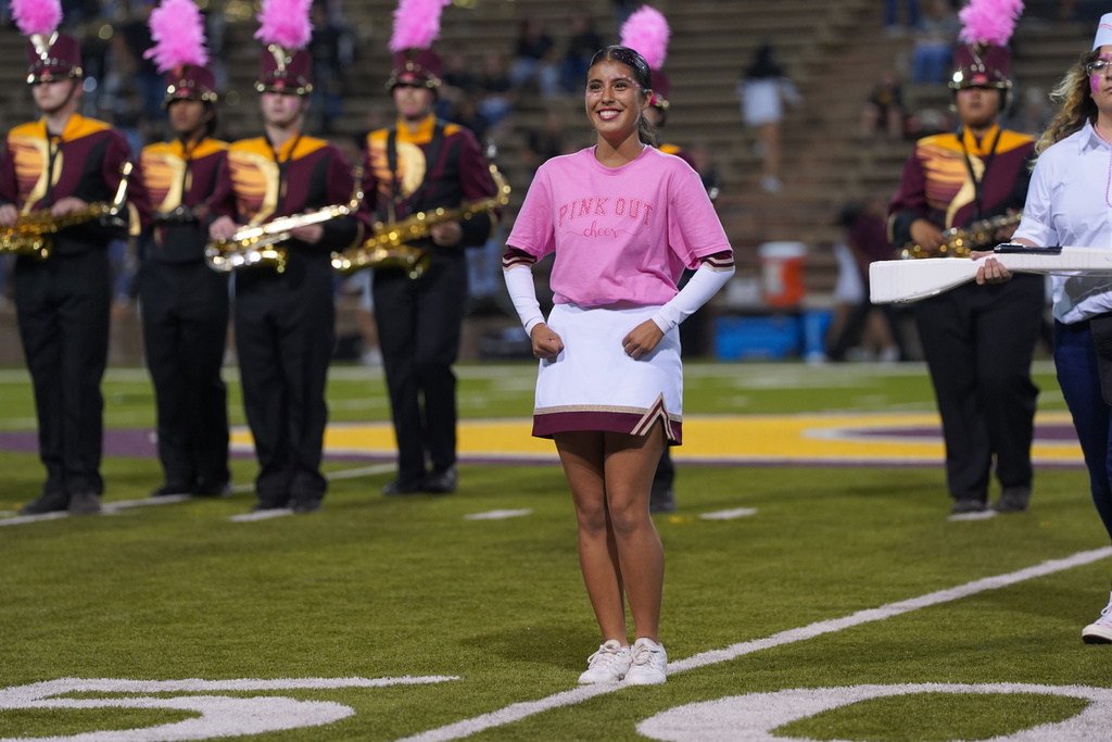 Drum major leading the band onto the field