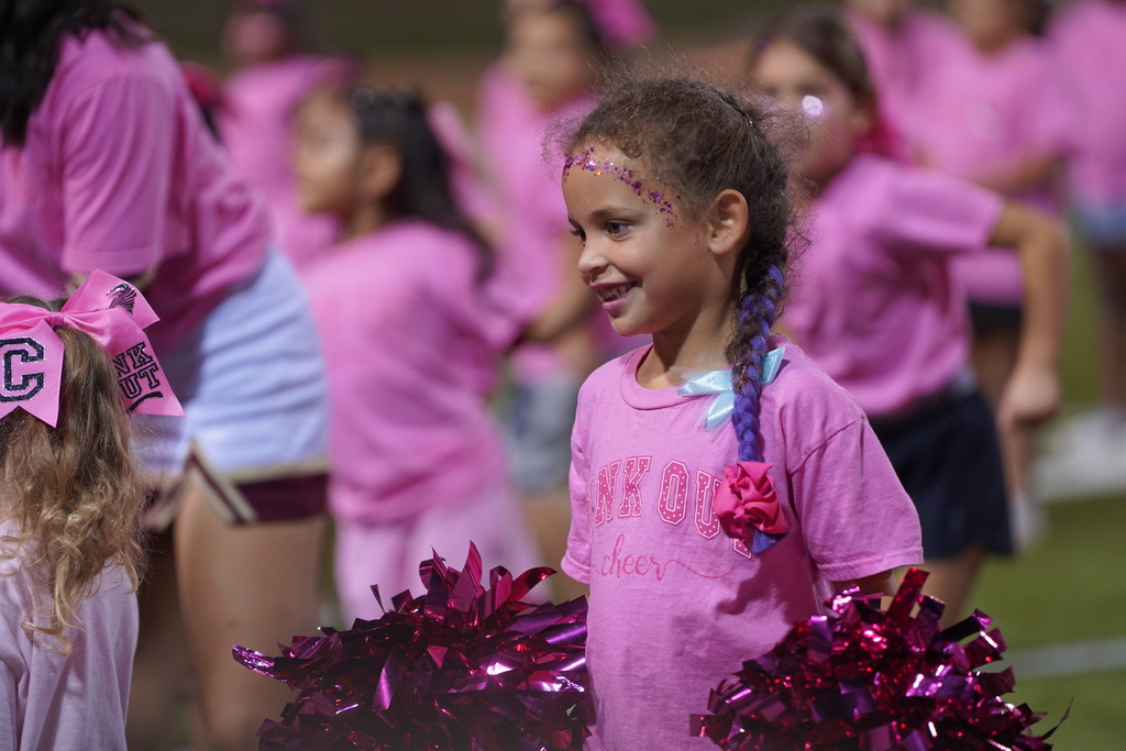 Mini cheerleader performing at halftime