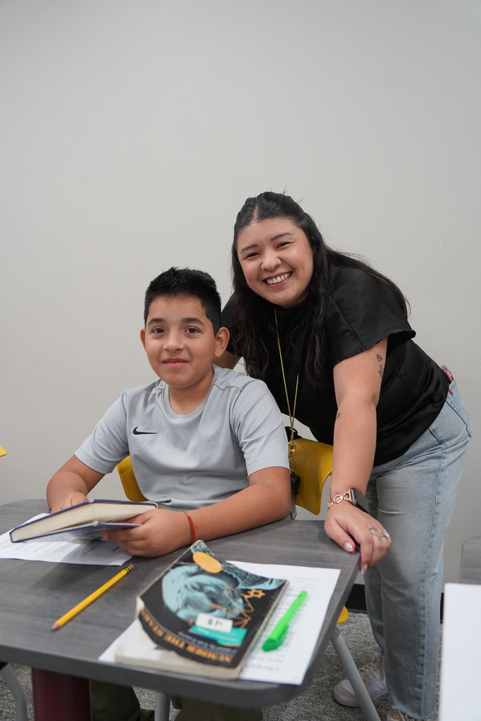 Teacher and student reading together