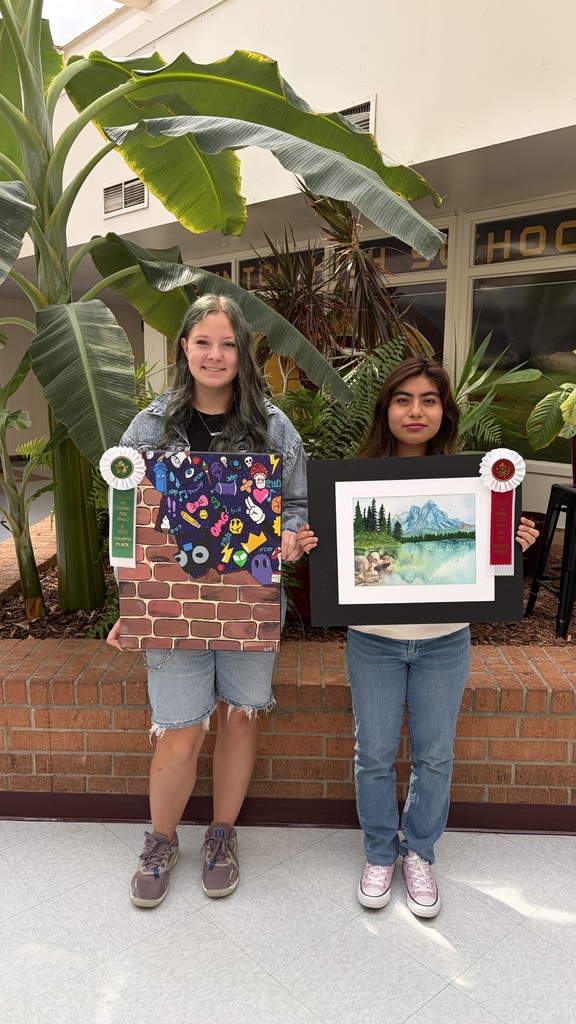 2 students holding their Oils/Acrylics and Watercolor art