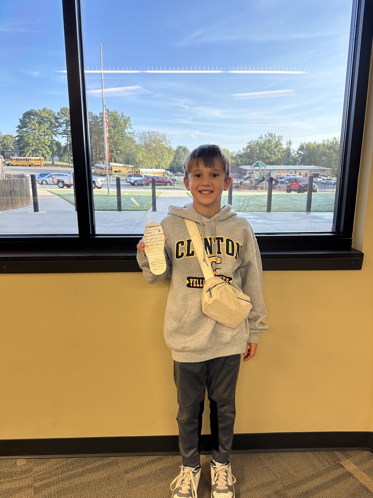 Little boy holding a foot cut out