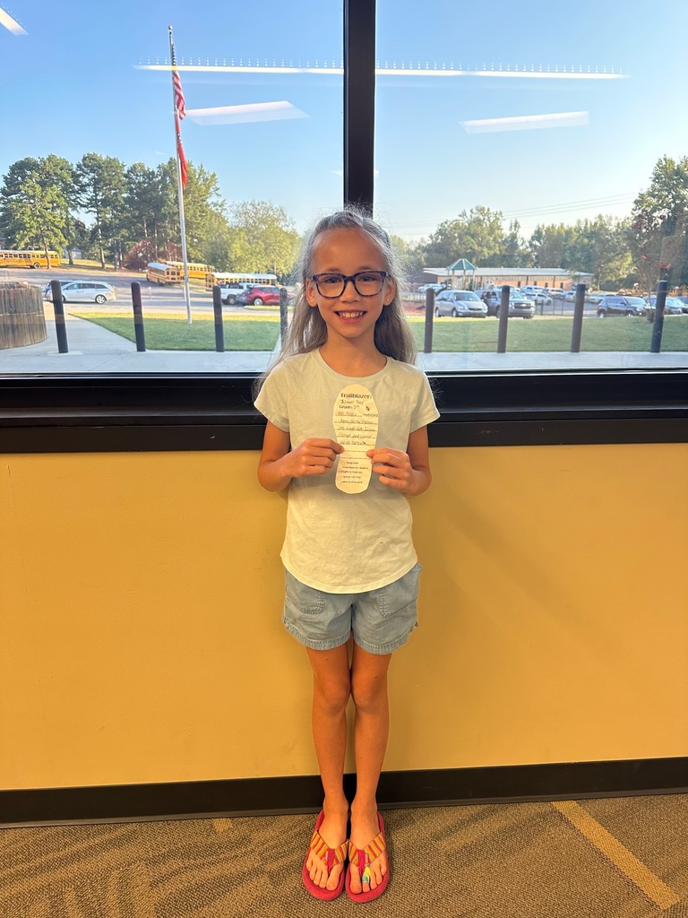 girl holding a paper foot