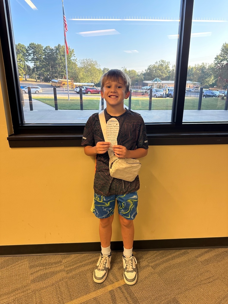 boy holding a paper foot