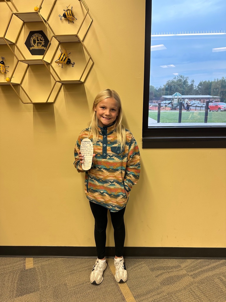 girl holding a paper foot