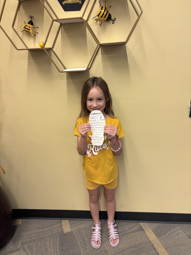 little girl in yellow holding a foot