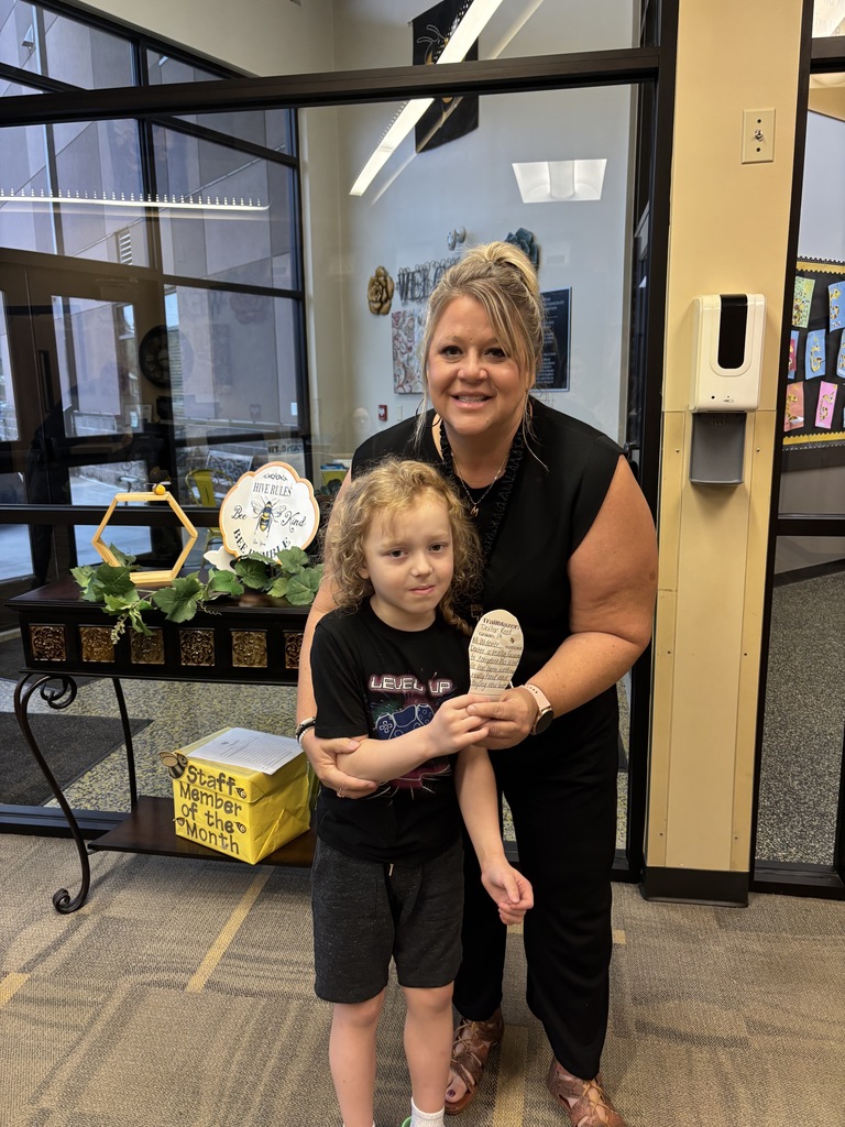 a little boy holding a cutout foot and a woman