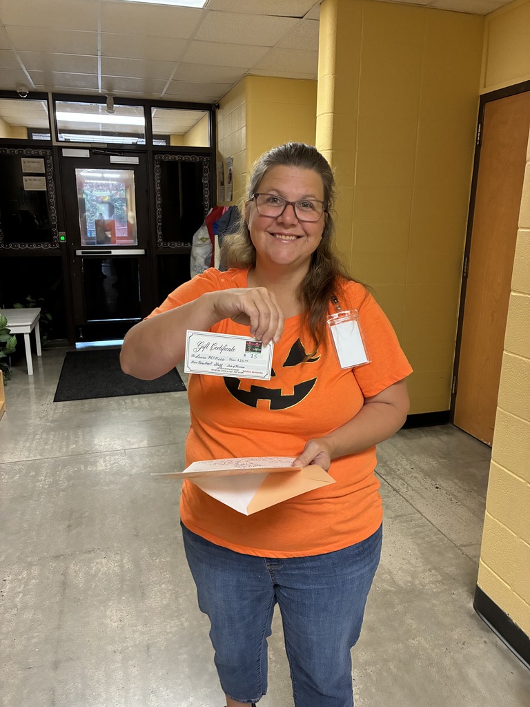 a woman in an orange pumpkin shirt
