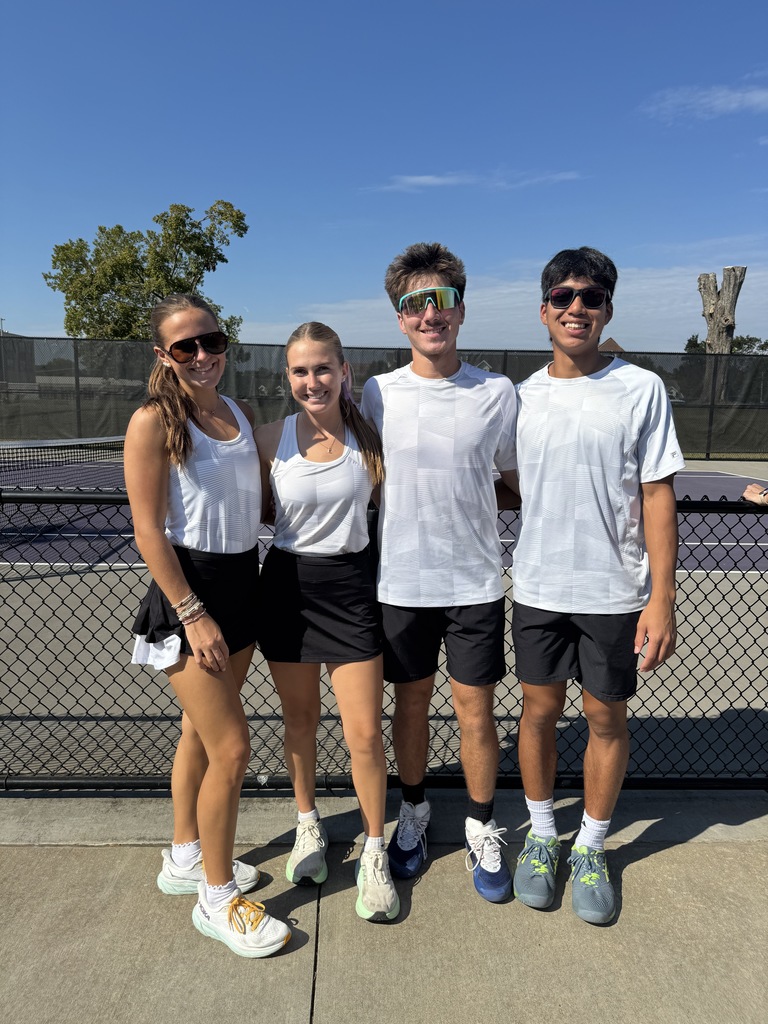 2 girls and 2 boys on a tennis court