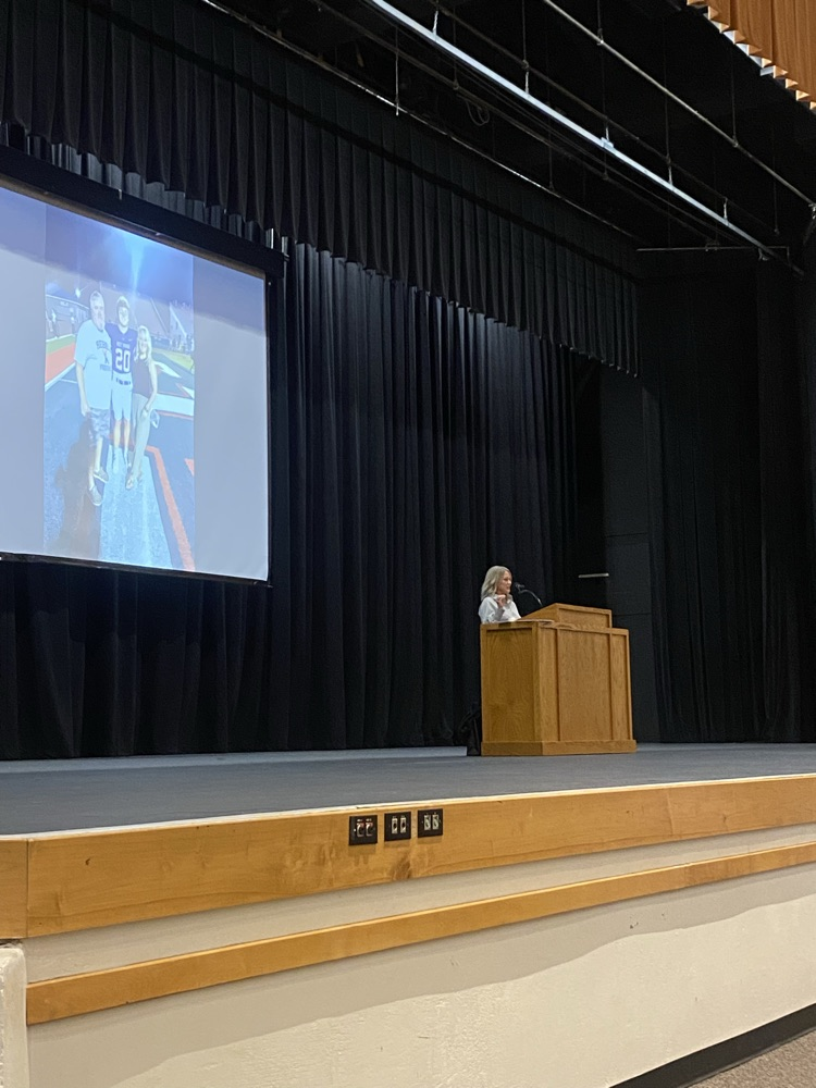 woman on a stage behind a podium