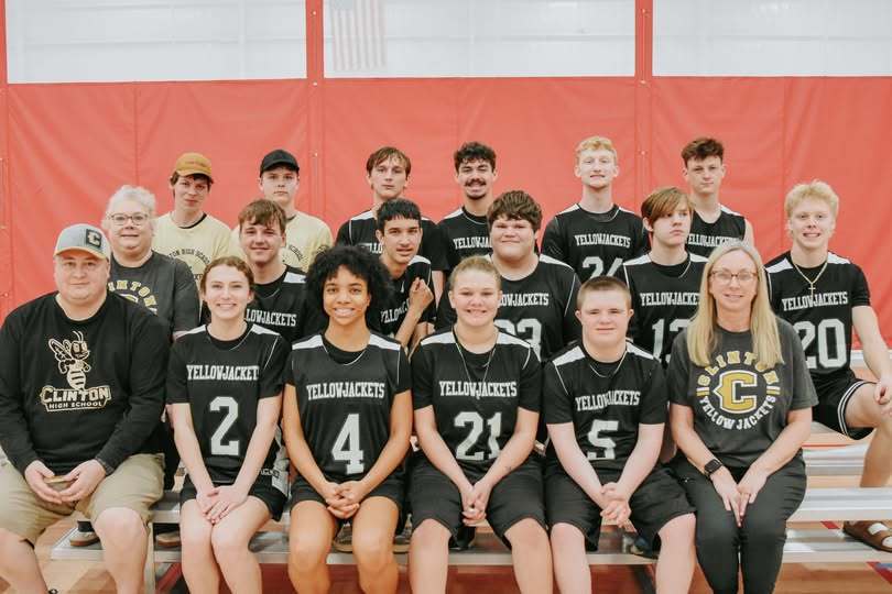 group of basketball players sitting on bleachers