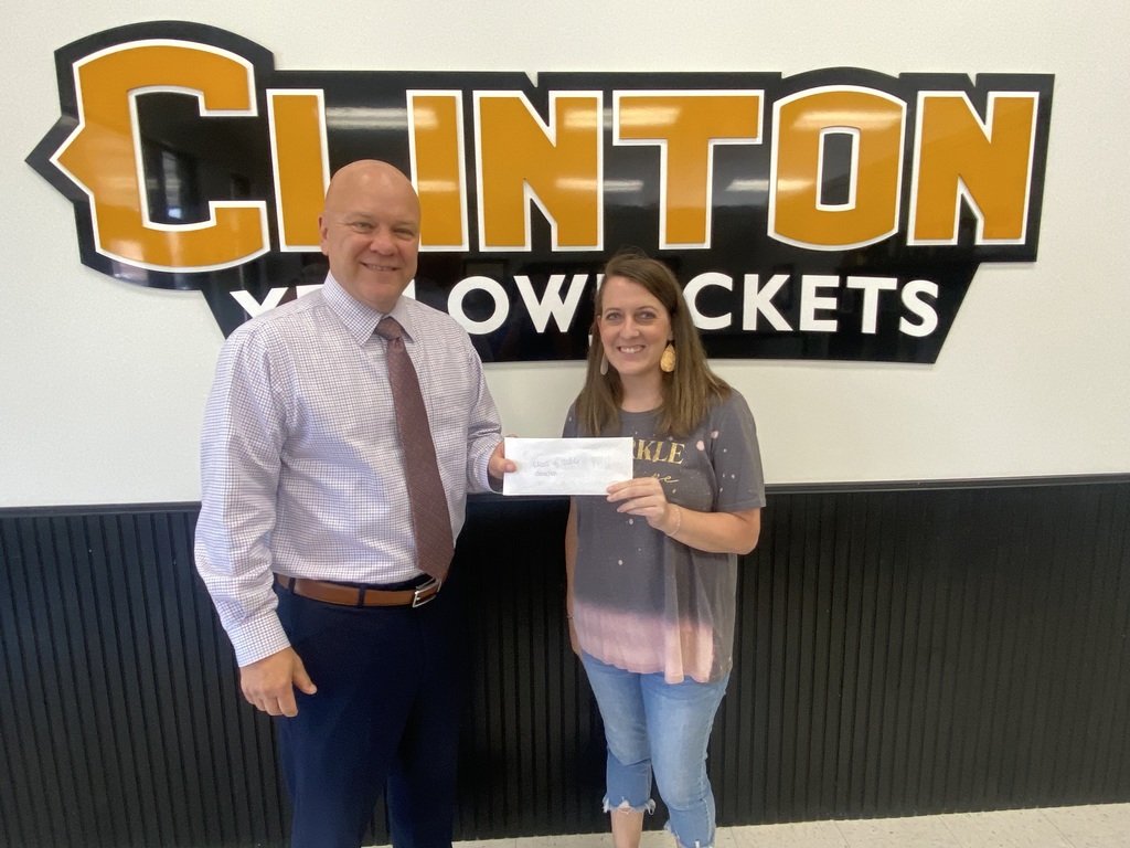 2 people holding a check