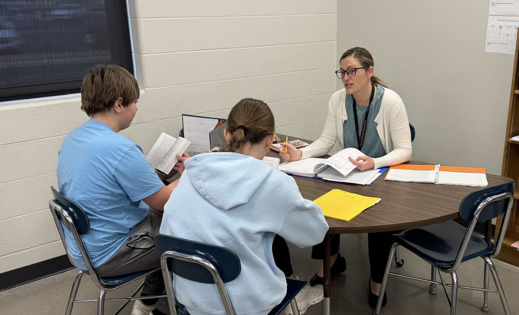 Mrs. Stevenson working with two 6th grade ELA students in a small group setting.